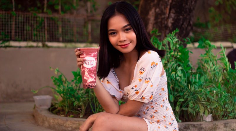 Photo by Penumbra Captures: https://www.pexels.com/photo/woman-in-floral-dress-smiling-while-holding-a-milk-tea-6221441/