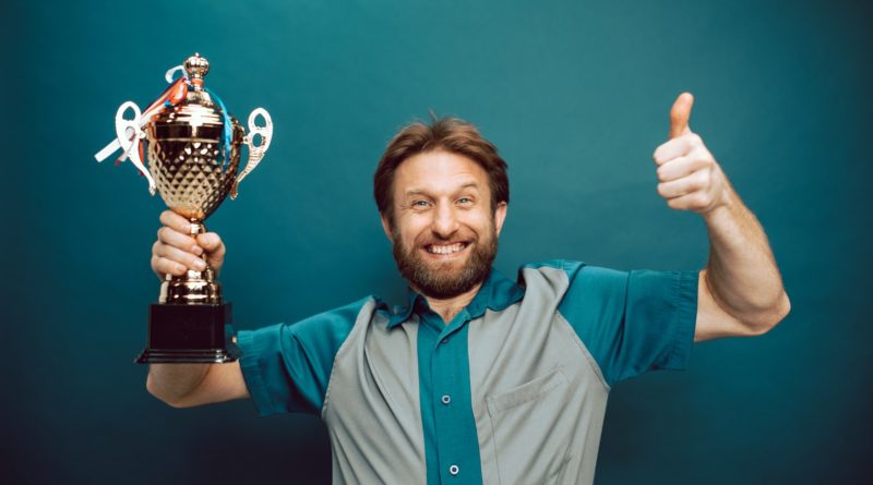 Photo by RODNAE Productions: https://www.pexels.com/photo/a-man-s-face-of-victory-holding-his-trophy-7005500/